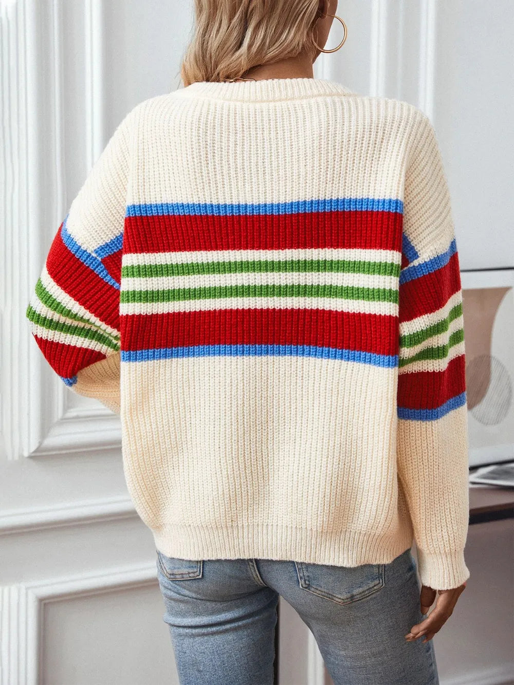 Cream round-neck knit sweater with multicolor horizontal stripes across the back, long sleeves