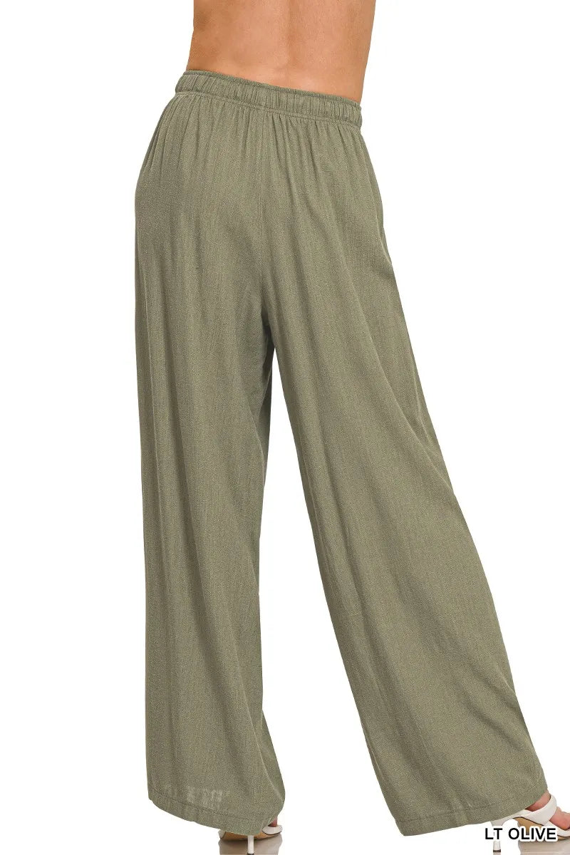 Light olive linen drawstring pants with elastic waist and roomy wide-leg silhouette