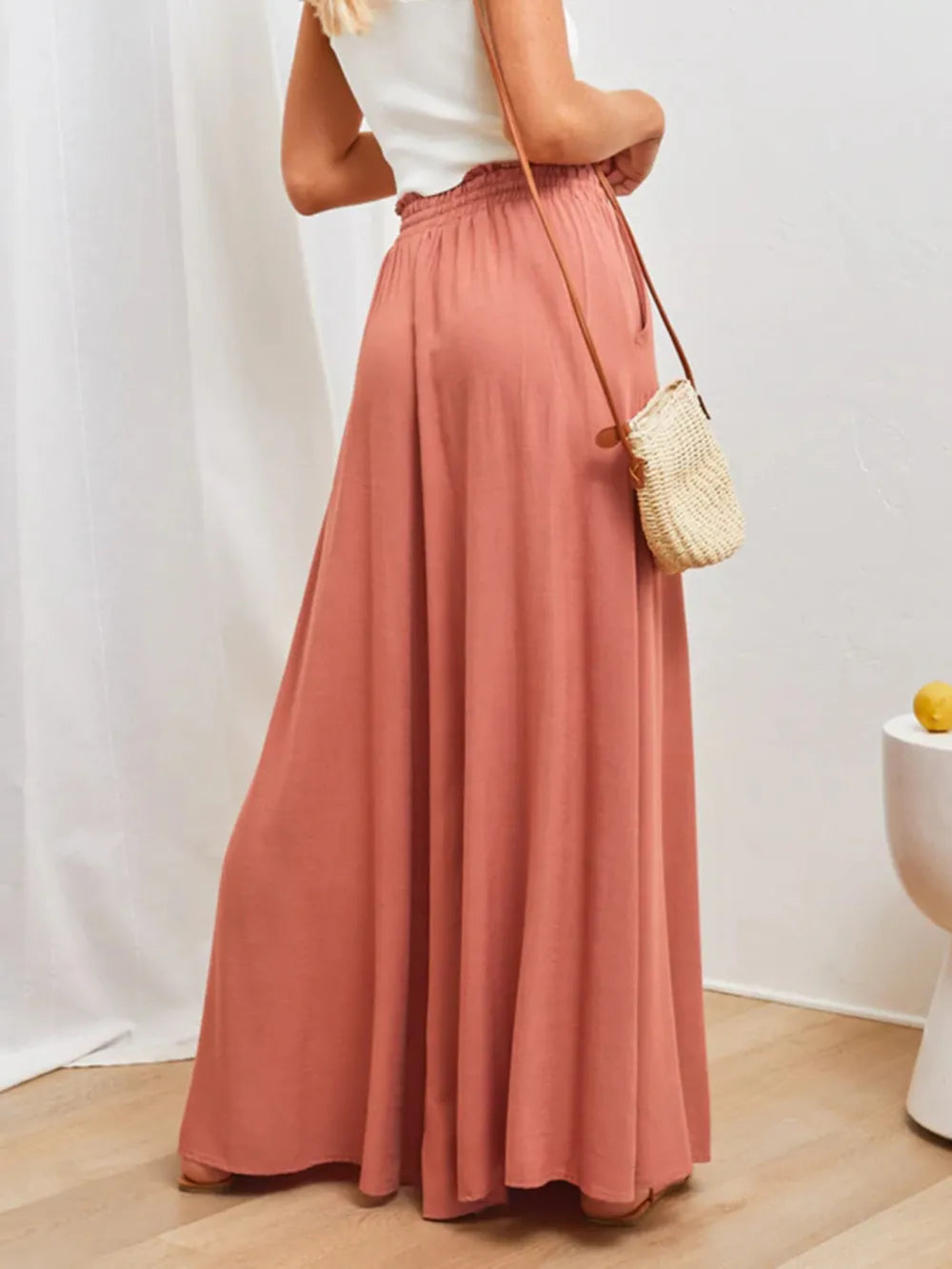 High-waist wide-leg pants in coral with elastic waist, drawstring tie, and full-length wide legs