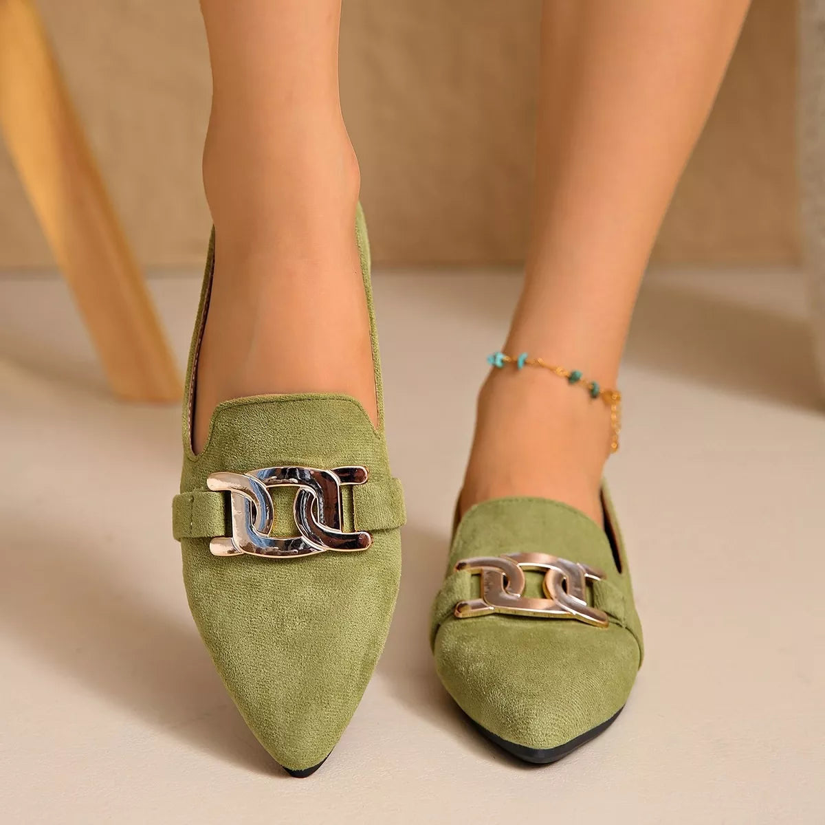 Matcha green suede pointed loafers with metallic chain link buckle detail