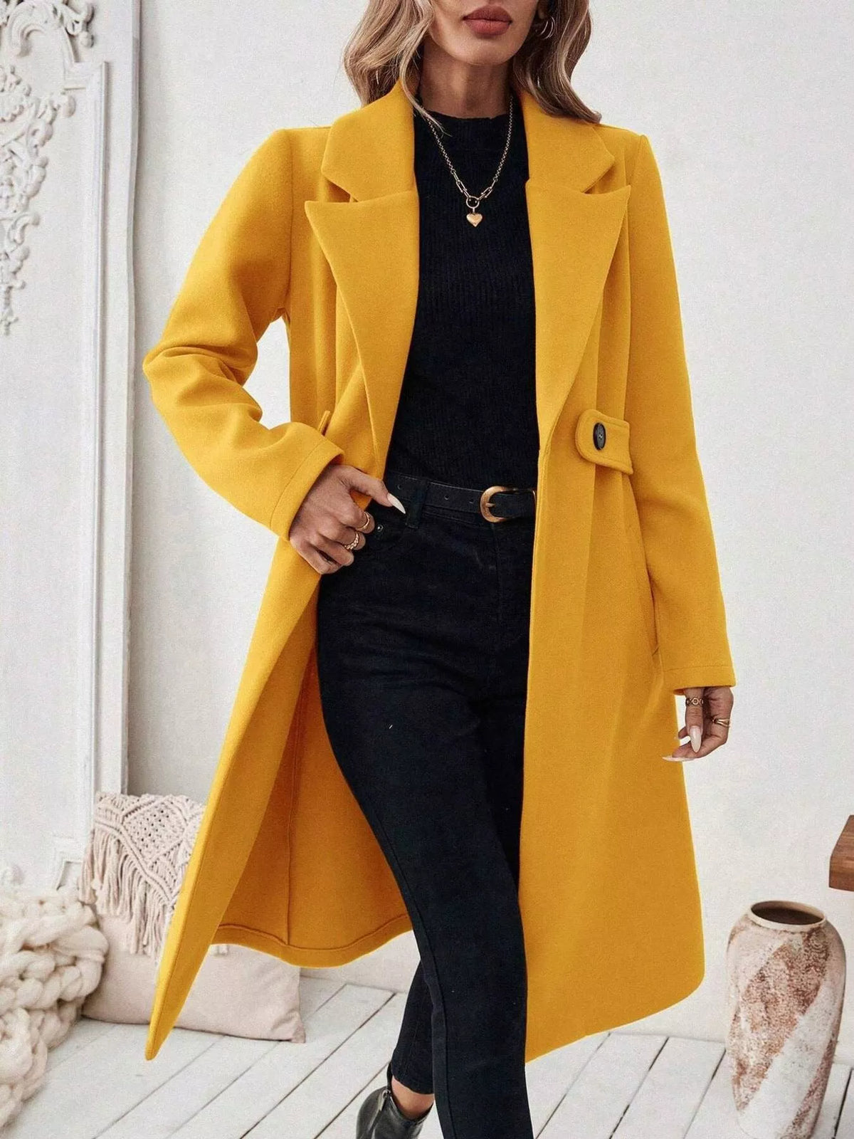 Yellow longline coat with notch lapels, flap pockets, and button closure
