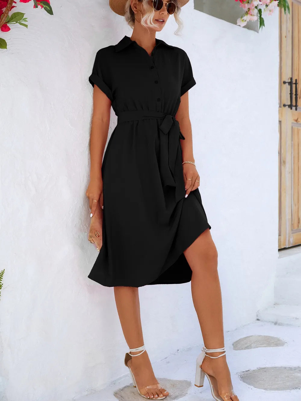 Black short sleeve tie-waist button-front dress, side view with belted waist detail
