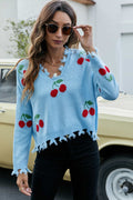 Sky blue cherry-print V-neck sweater with frayed trim along hem