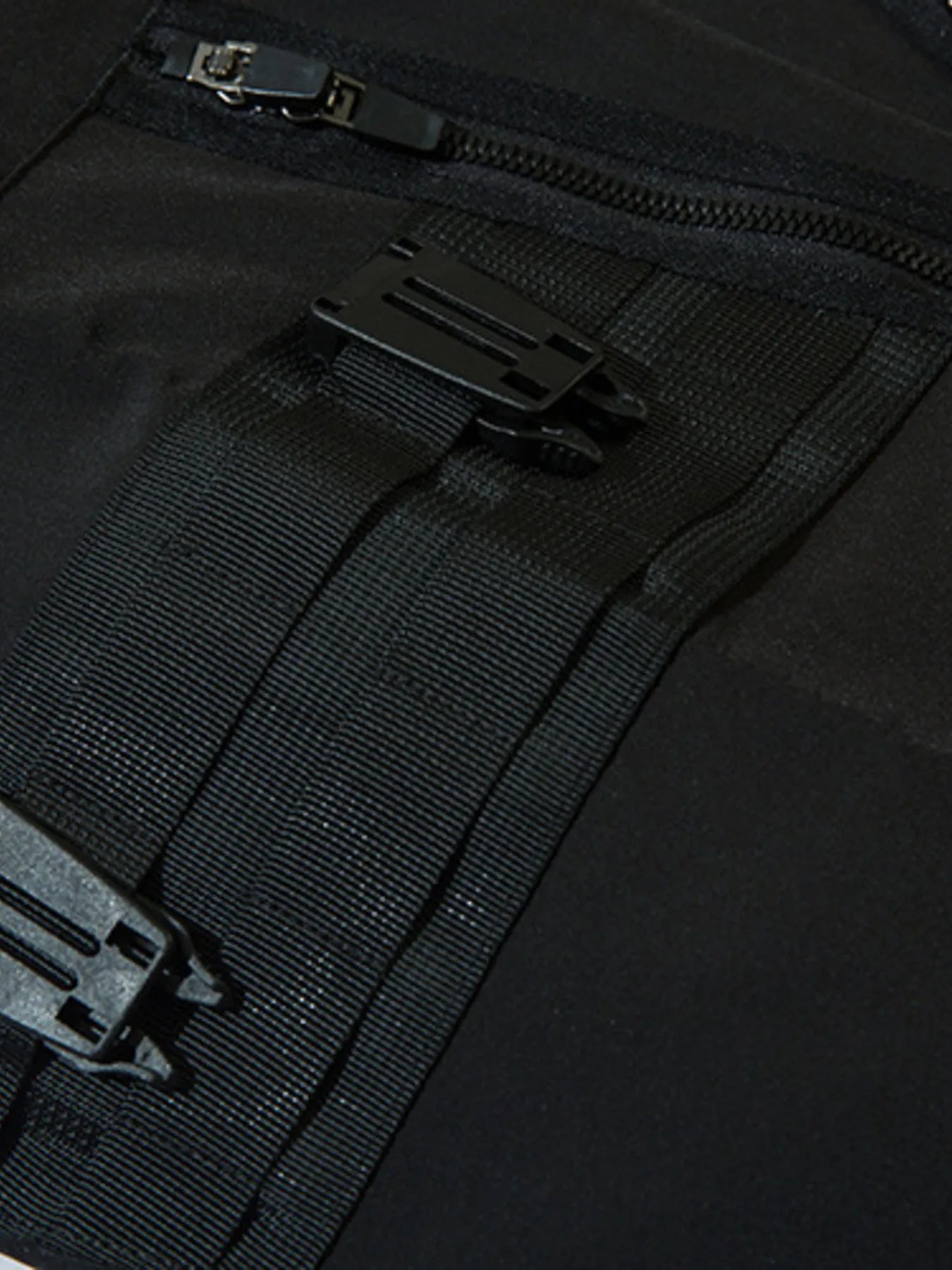 Black cargo joggers with textured zip pocket lining and zipper hardware detail