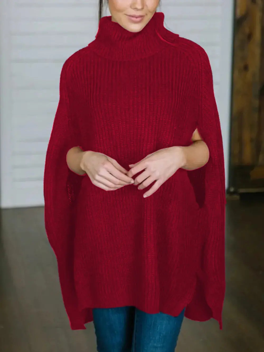 Burgundy turtleneck slit sweater with ribbed knit and draped side hem.