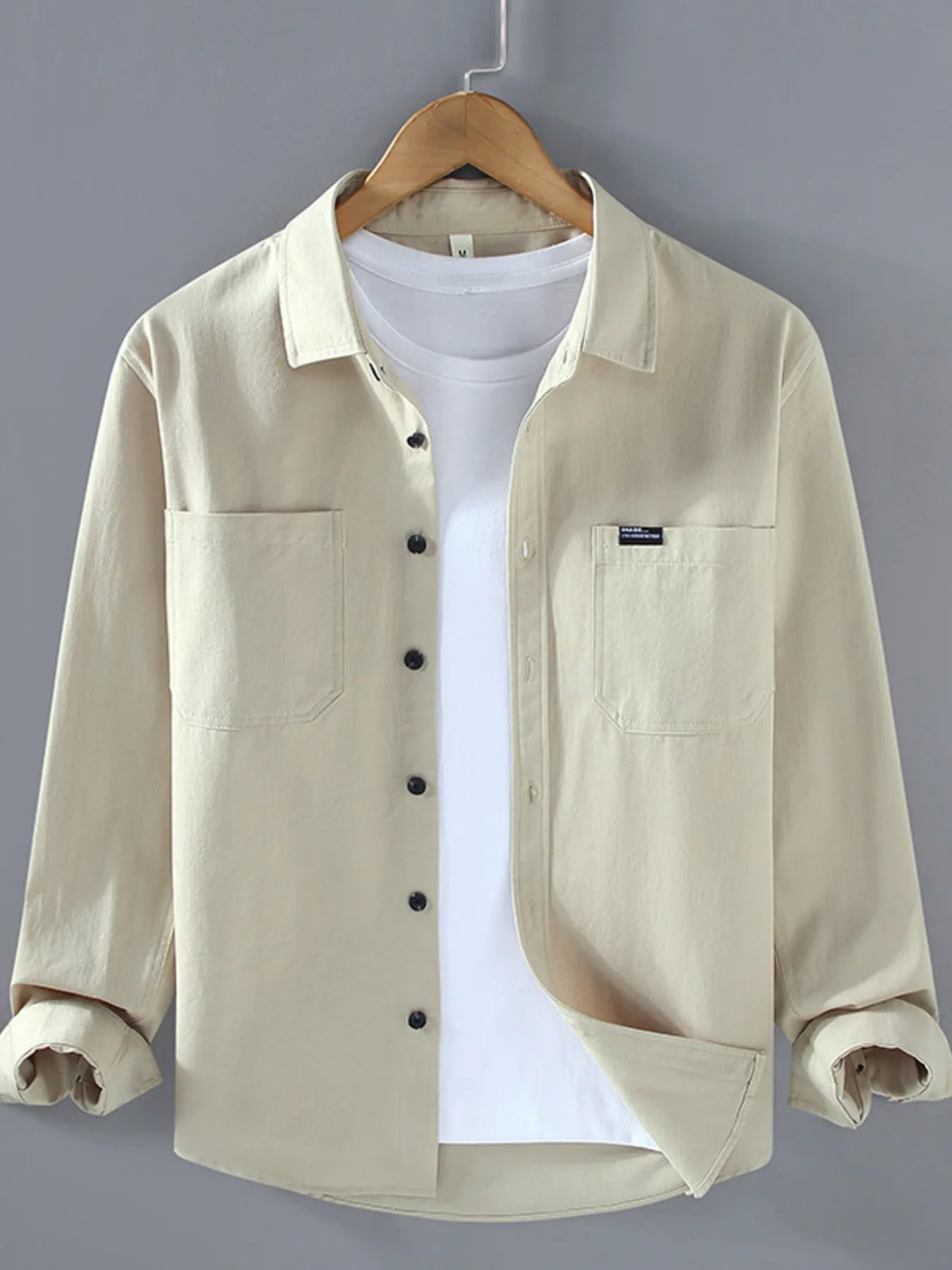Beige long sleeve button-up shirt with chest pockets and button front