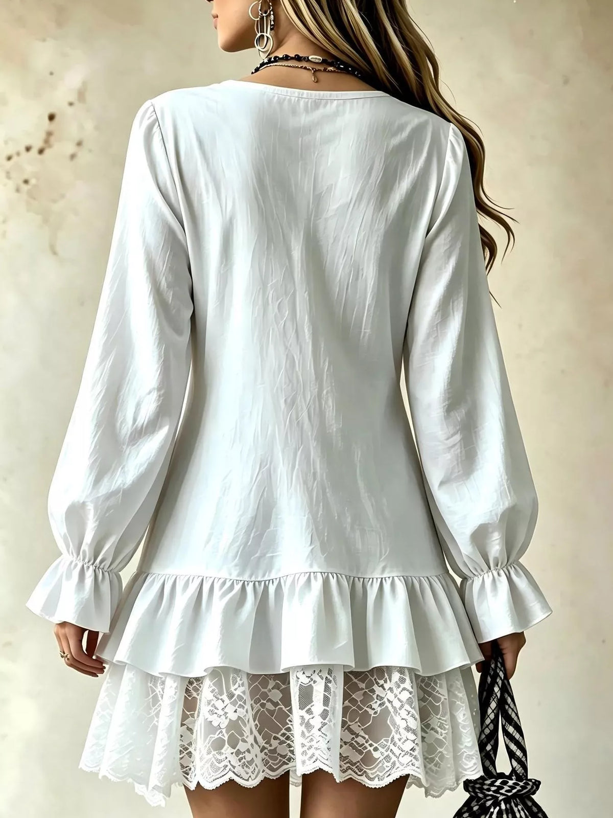 Back view of white V-neck mini dress with lace ruffle hem and puff sleeves