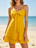Yellow spaghetti strap mini dress with bow front and tiered flared skirt