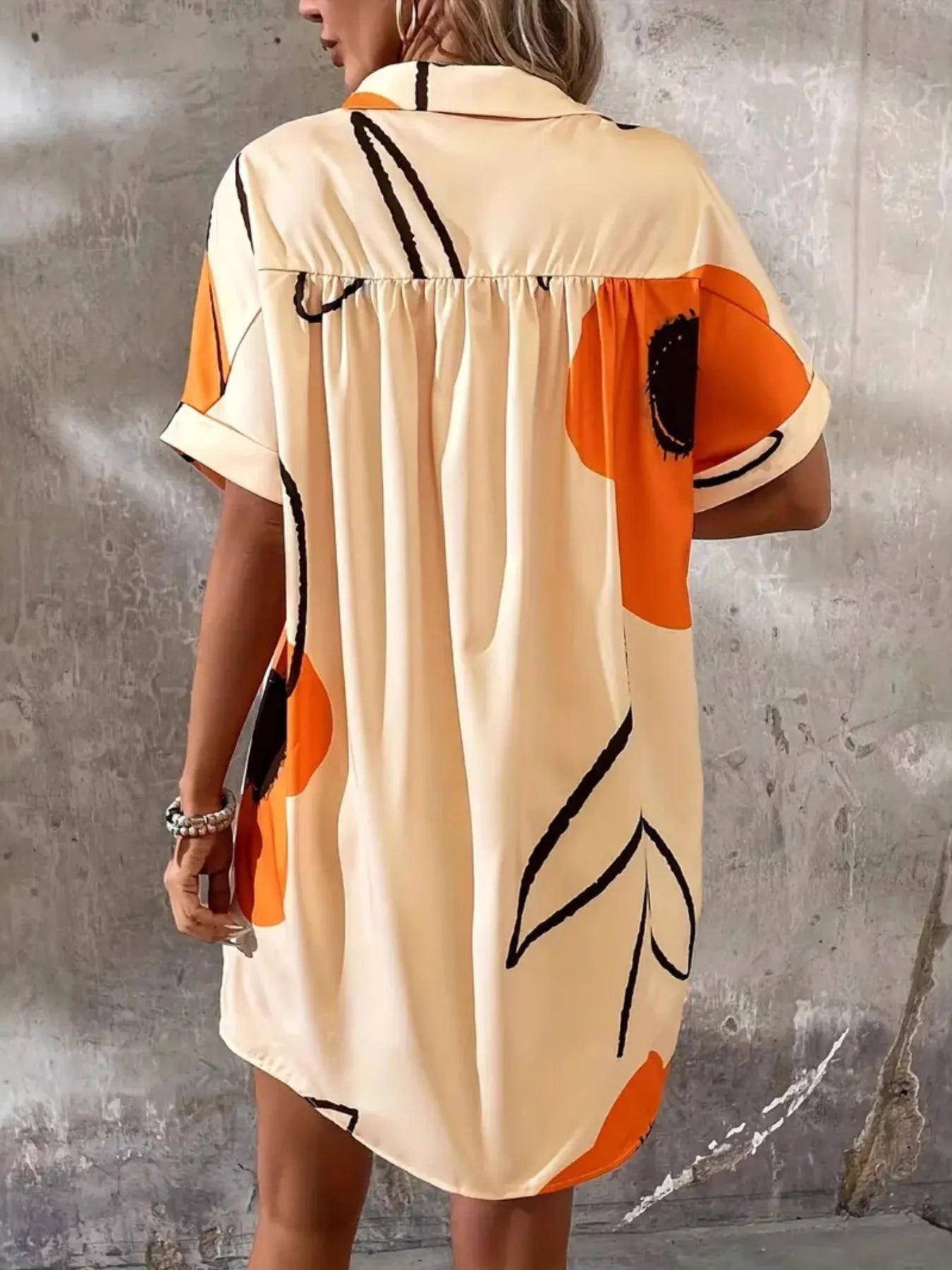 Printed Button-Front Shirt Dress by Trendsi in beige with orange and black abstract pattern.