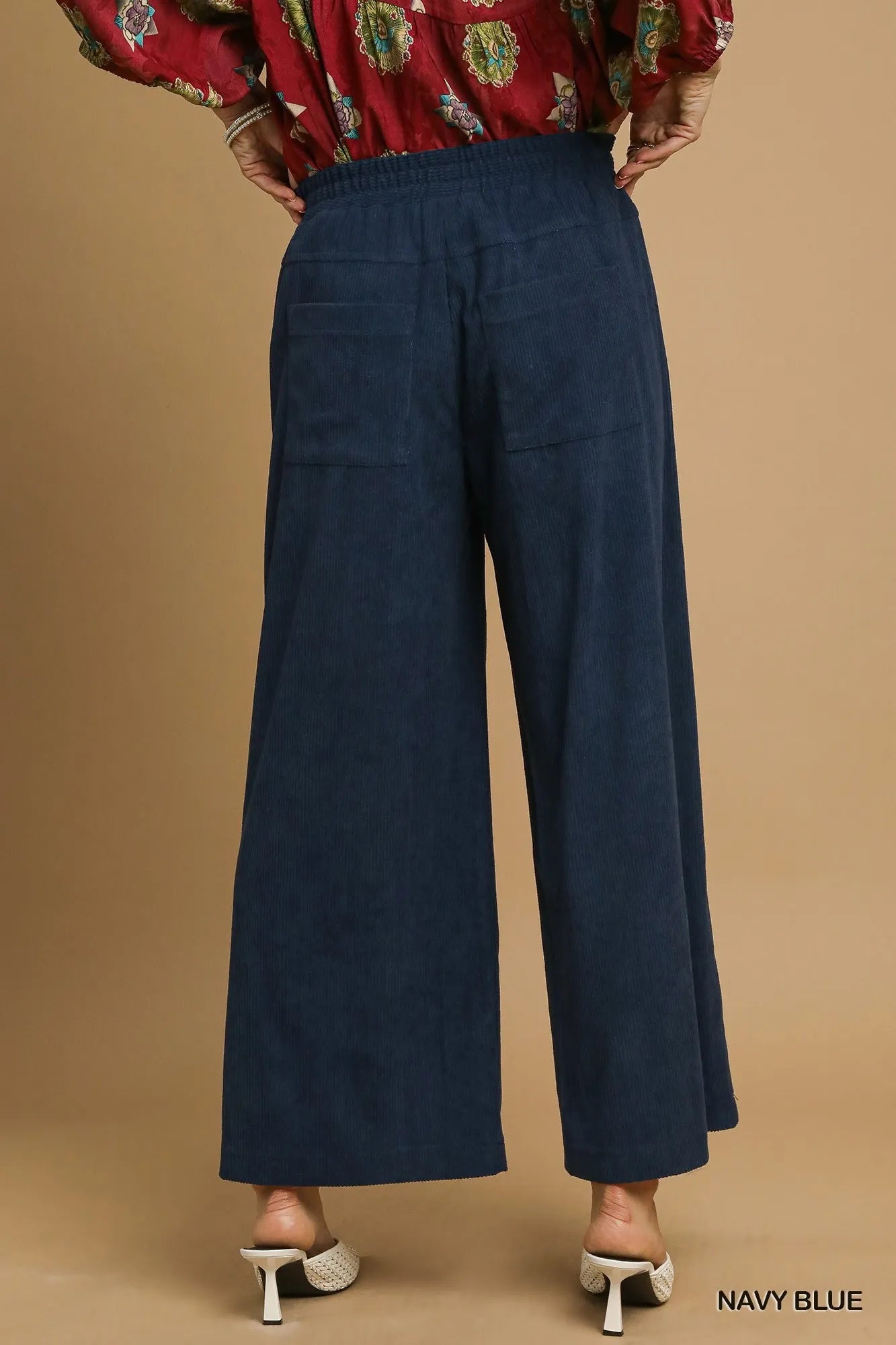 Navy blue corduroy wide-leg pants from back view with elastic waist