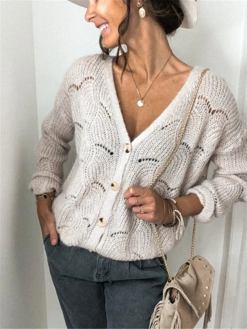 Beige openwork button-up cardigan with V-neck and long sleeves, front button placket.