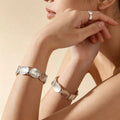 Silver textured oval charm bracelet with hinged links