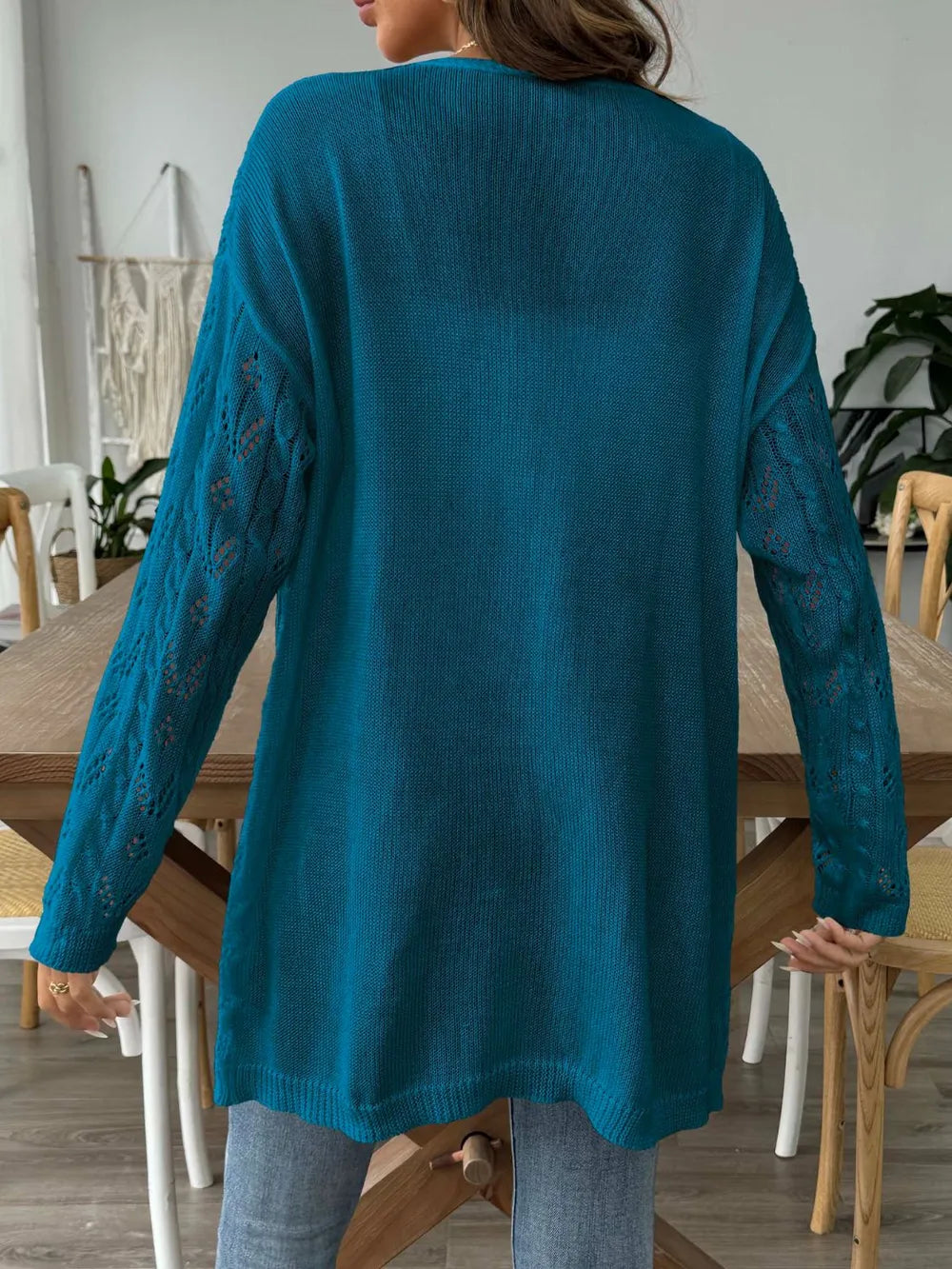 Peacock blue openwork long-sleeve cardigan, open front, textured knit back view.