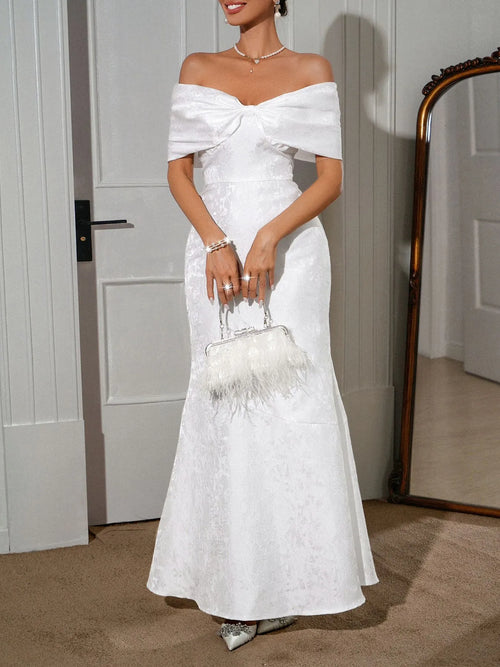 White off-shoulder maxi dress with waist bow, textured bodice and skirt