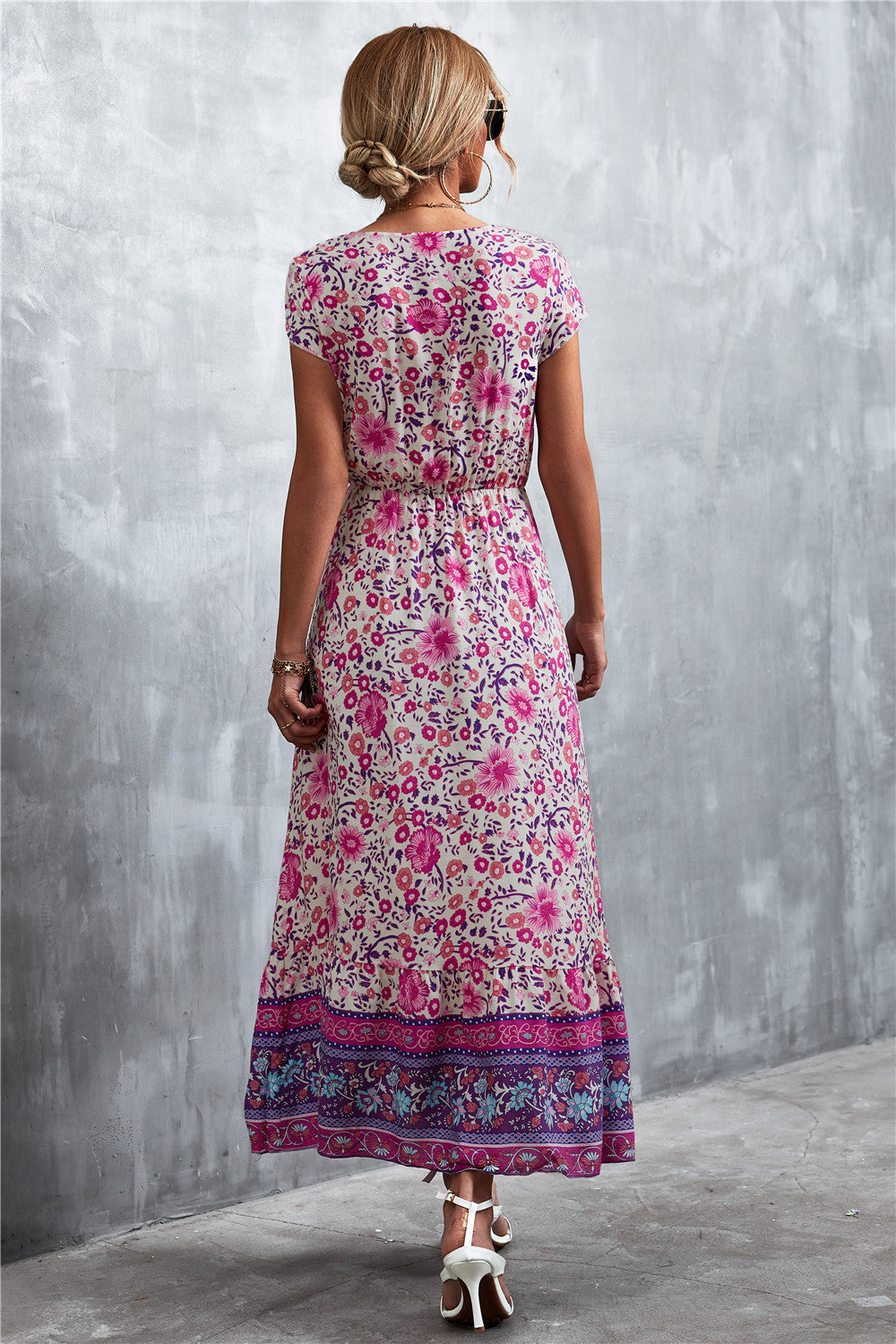 V-neck printed maxi dress with short sleeves, purple base, pink floral pattern, rear view.