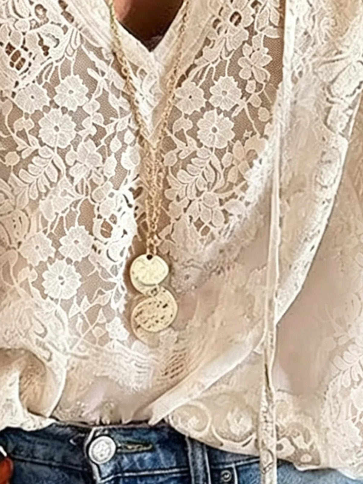 White lace blouse detail with V-neck and embroidered floral openwork