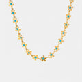 Gold-tone flower bead drip necklace with small blue clover motifs, open chain