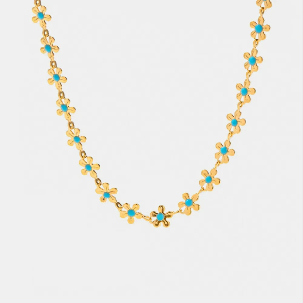 Gold-tone flower bead drip necklace with small blue clover motifs, open chain