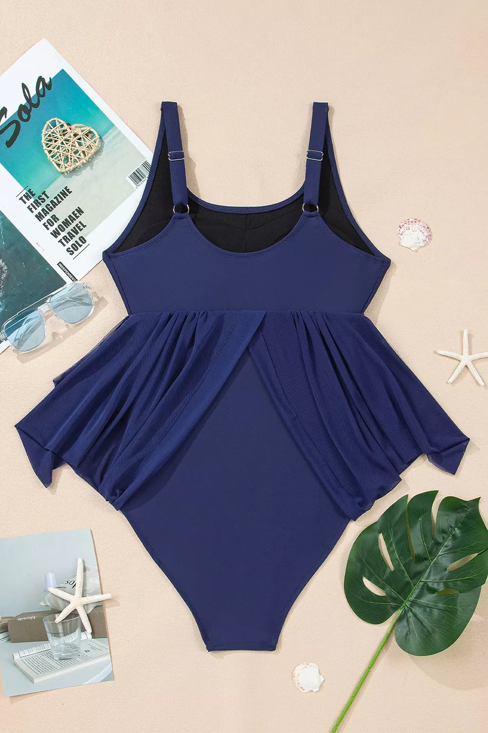 Navy V-neck one-piece swimsuit with wide straps and draped skirt panel