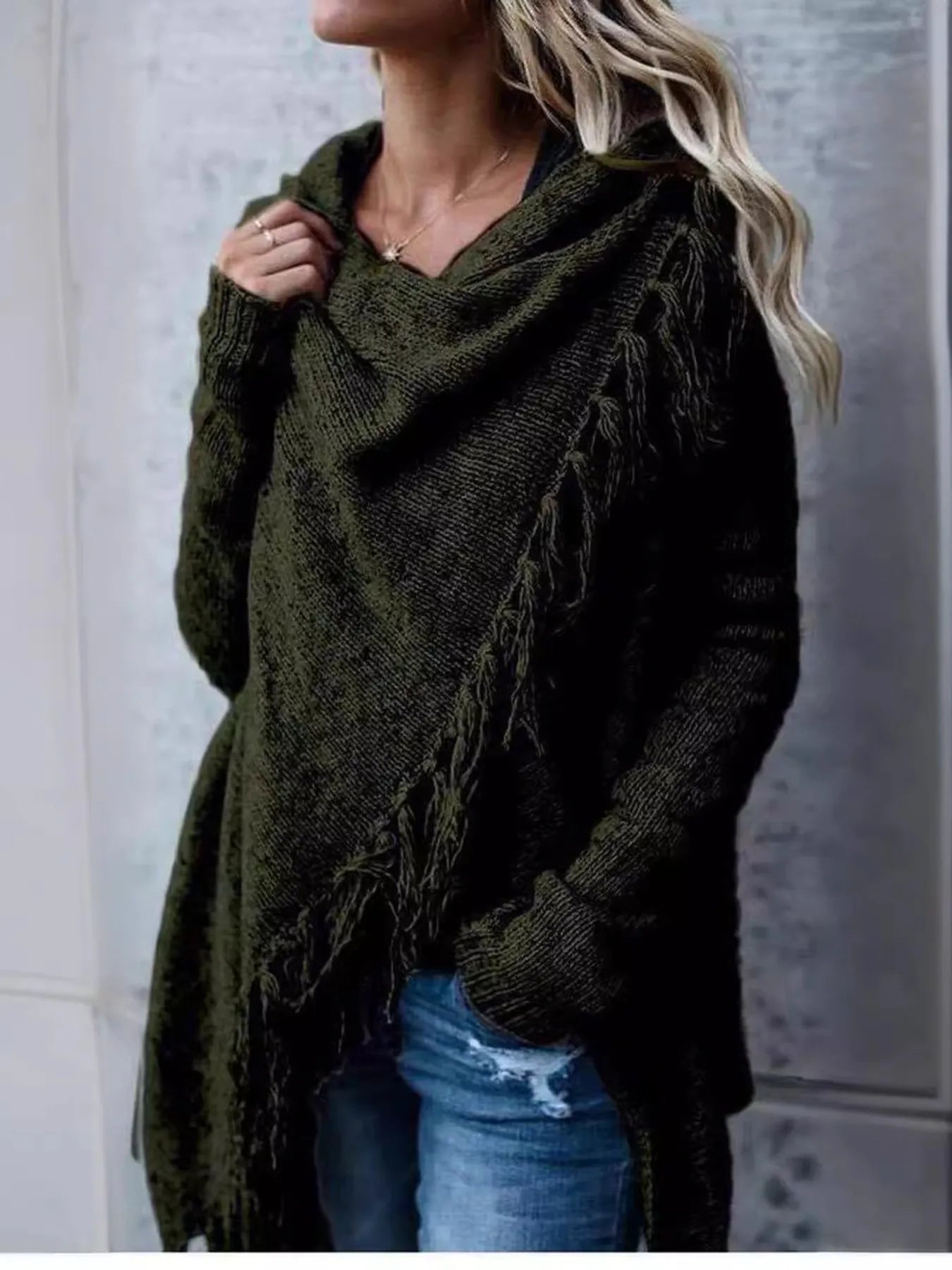 Dark green wrap cardigan with long sleeves, fringe detail, and cowl-style neckline