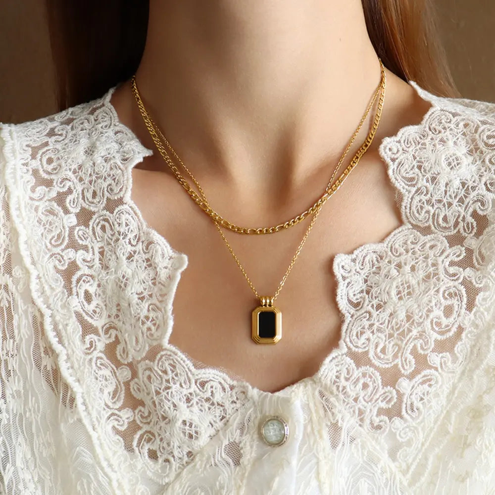 Gold-plated pendant necklace with rectangular black center on double chain