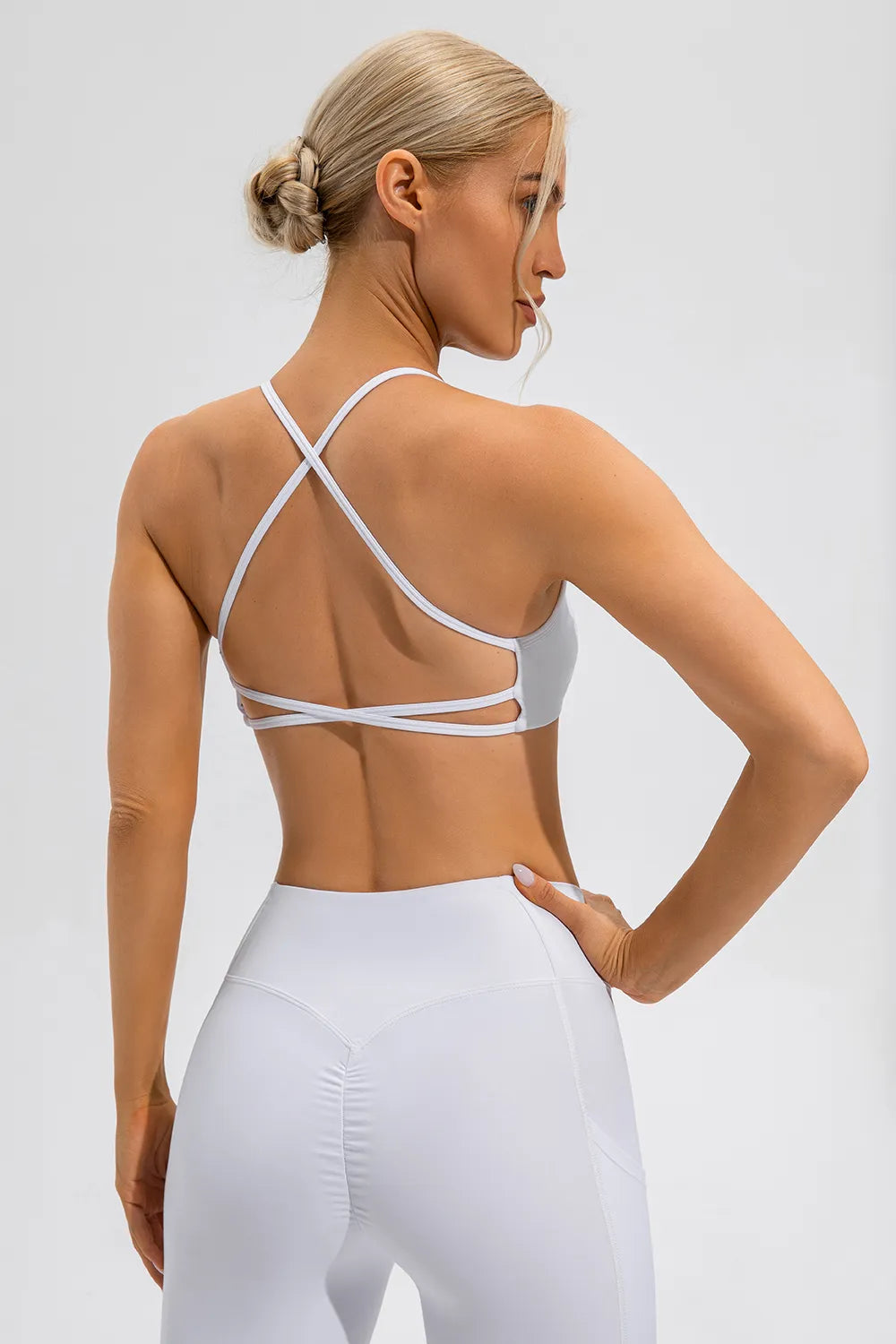 White active cami with crisscross open back and thin spaghetti straps