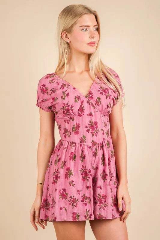 Pink floral ruffle-sleeve romper with V-neck and gathered waist, front full length