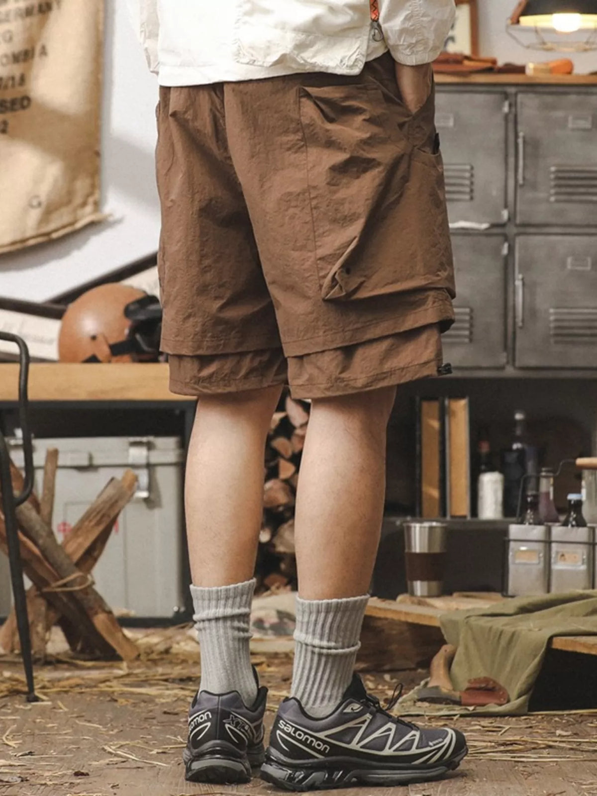 Brown men's cargo shorts with drawstring waist and cargo pockets, knee-length