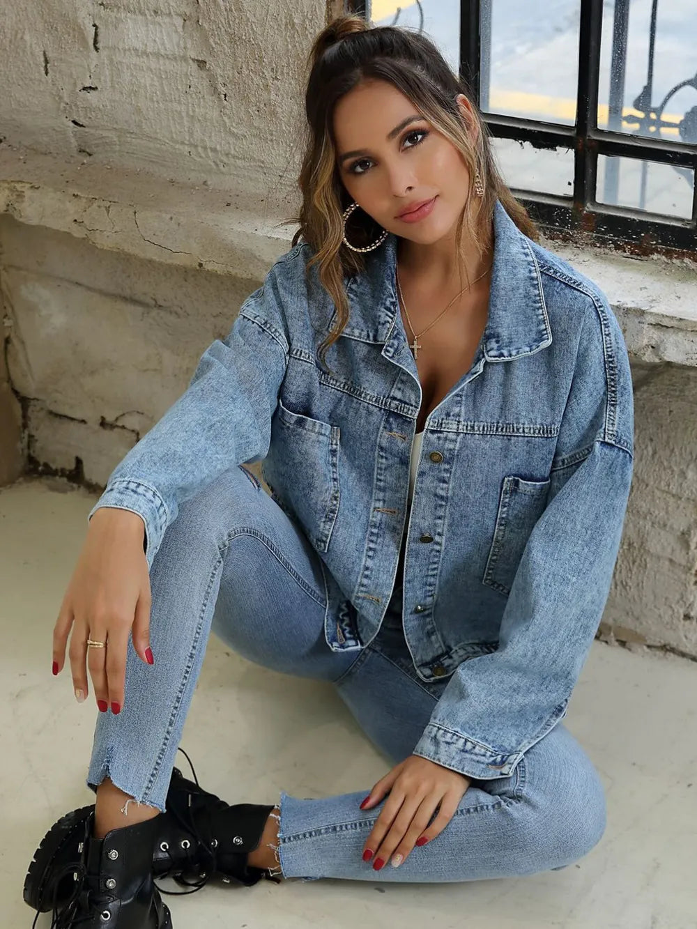Light-wash denim button-front drop-shoulder jacket with collar, buttons, and pockets