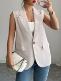 Eggshell sleeveless blazer with one button, notched lapels, and flap pockets
