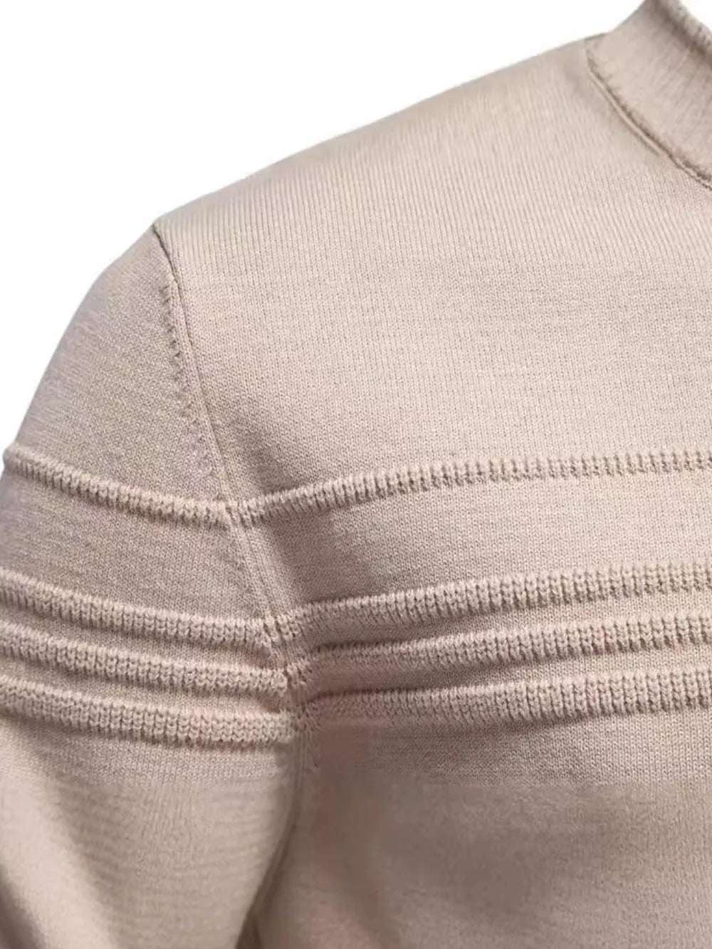 Beige knit sweater with round neck and striped panel detailing; close-up of texture