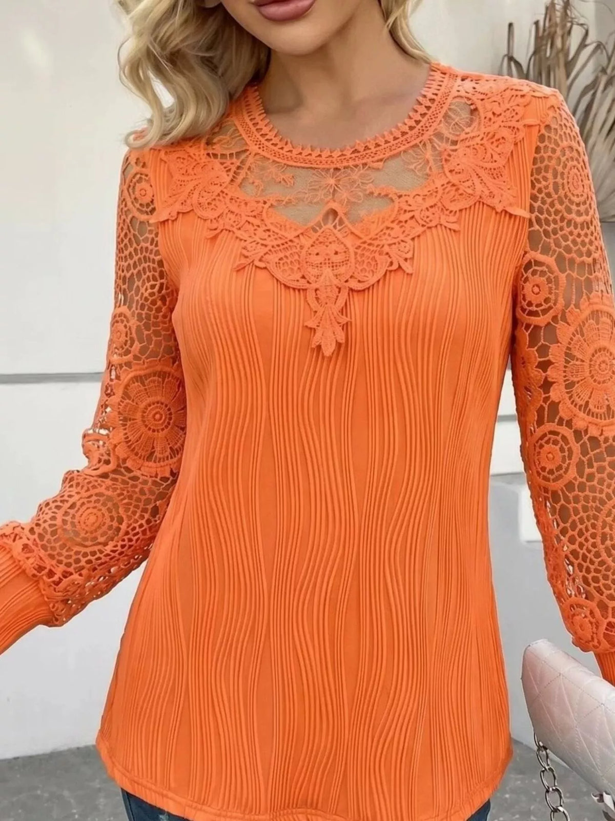 Orange lace patchwork long-sleeve blouse with lace shoulder overlay and pleated vertical texture
