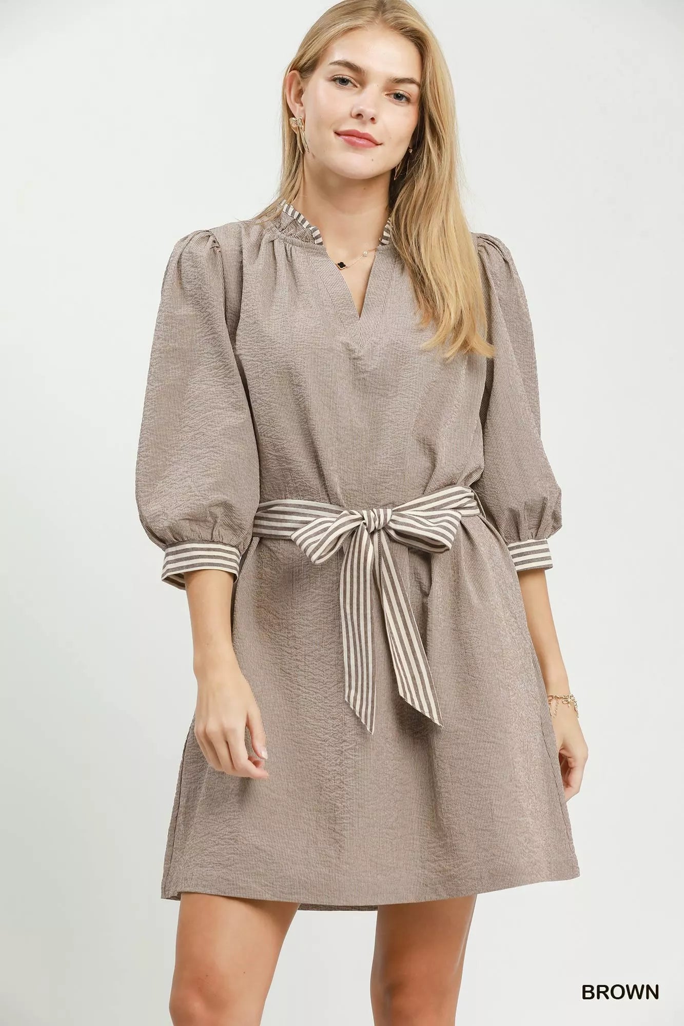Brown textured mini dress with gathered neckline, tie waist belt, striped contrast trim cuffs