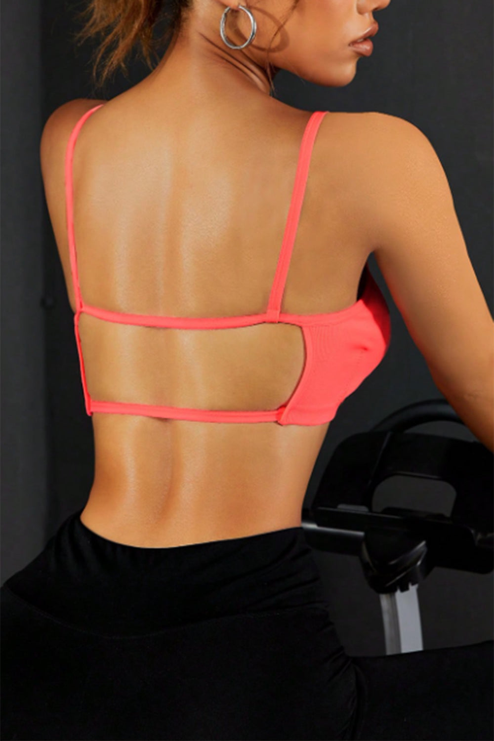 Coral back sports cami with open back and cross straps.