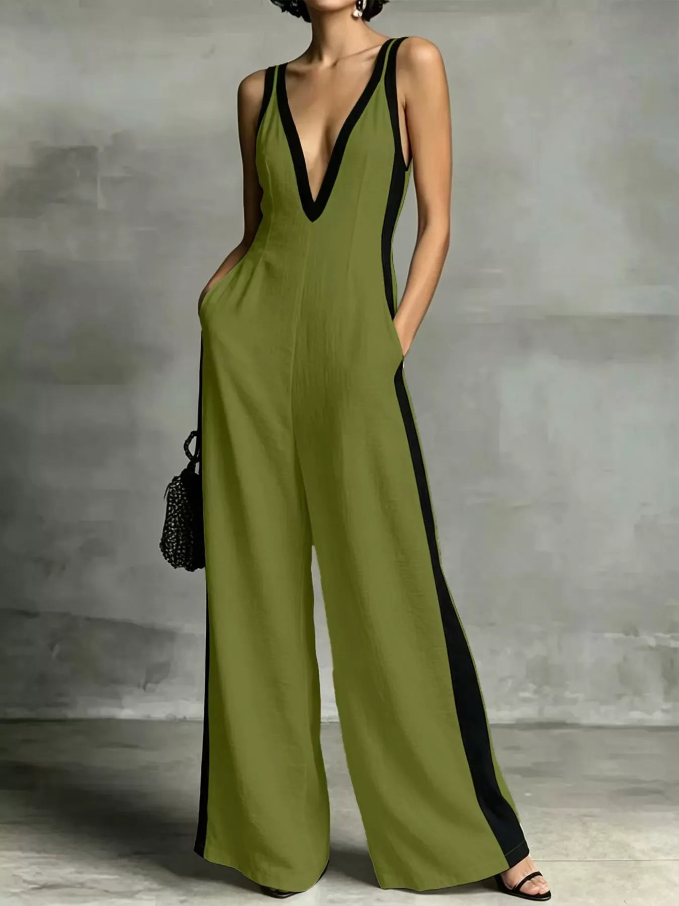 Olive green deep V-neck wide-leg jumpsuit with black contrast trim, sleeveless