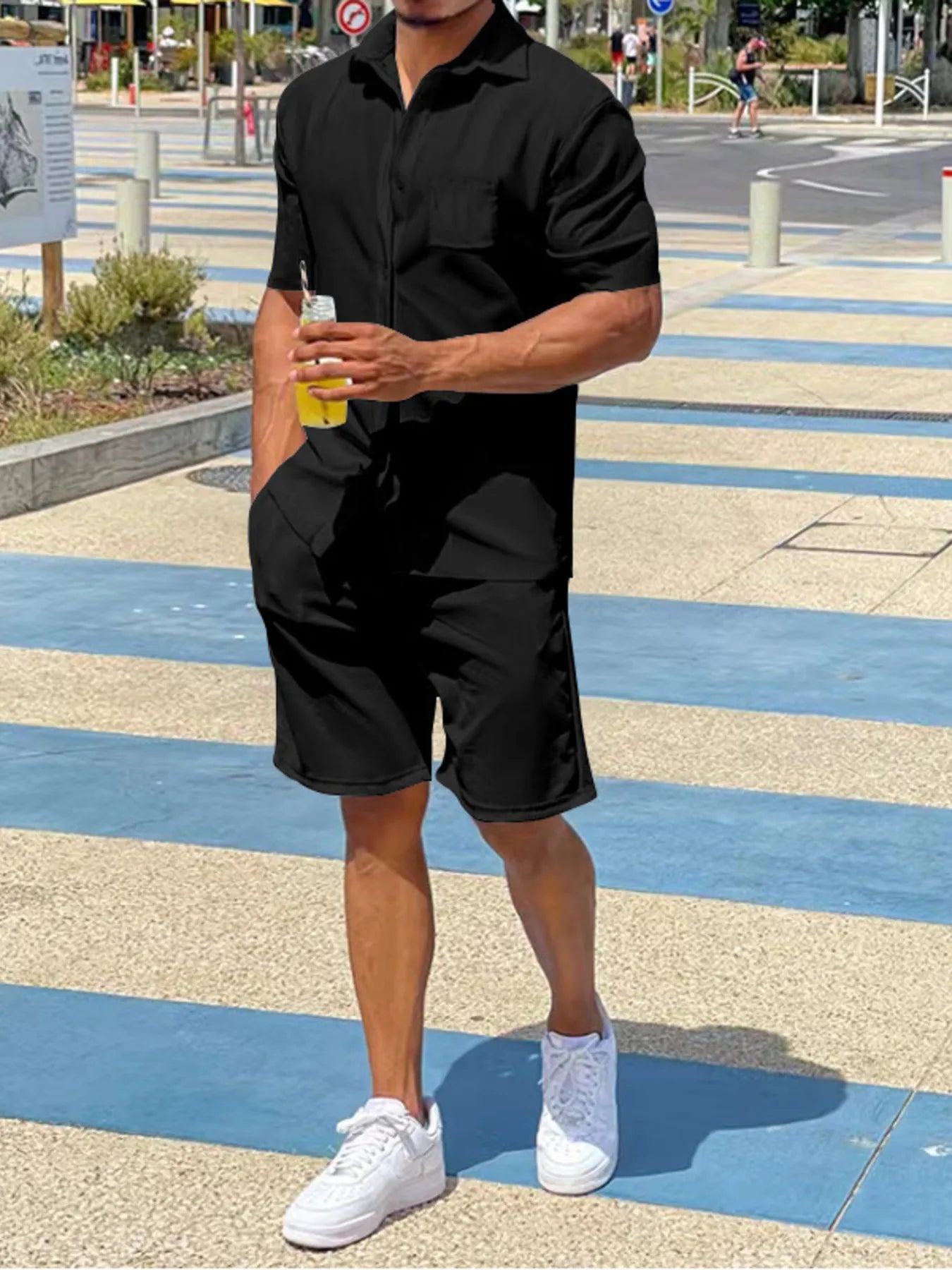 Black short-sleeve button-up shirt and matching shorts set, front view