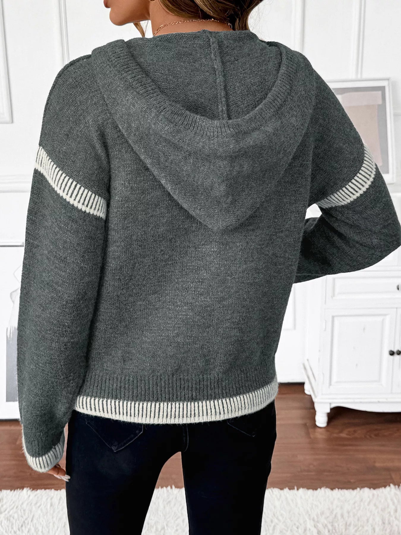 Dark gray hooded quarter-zip sweater from back with white striped sleeve trim
