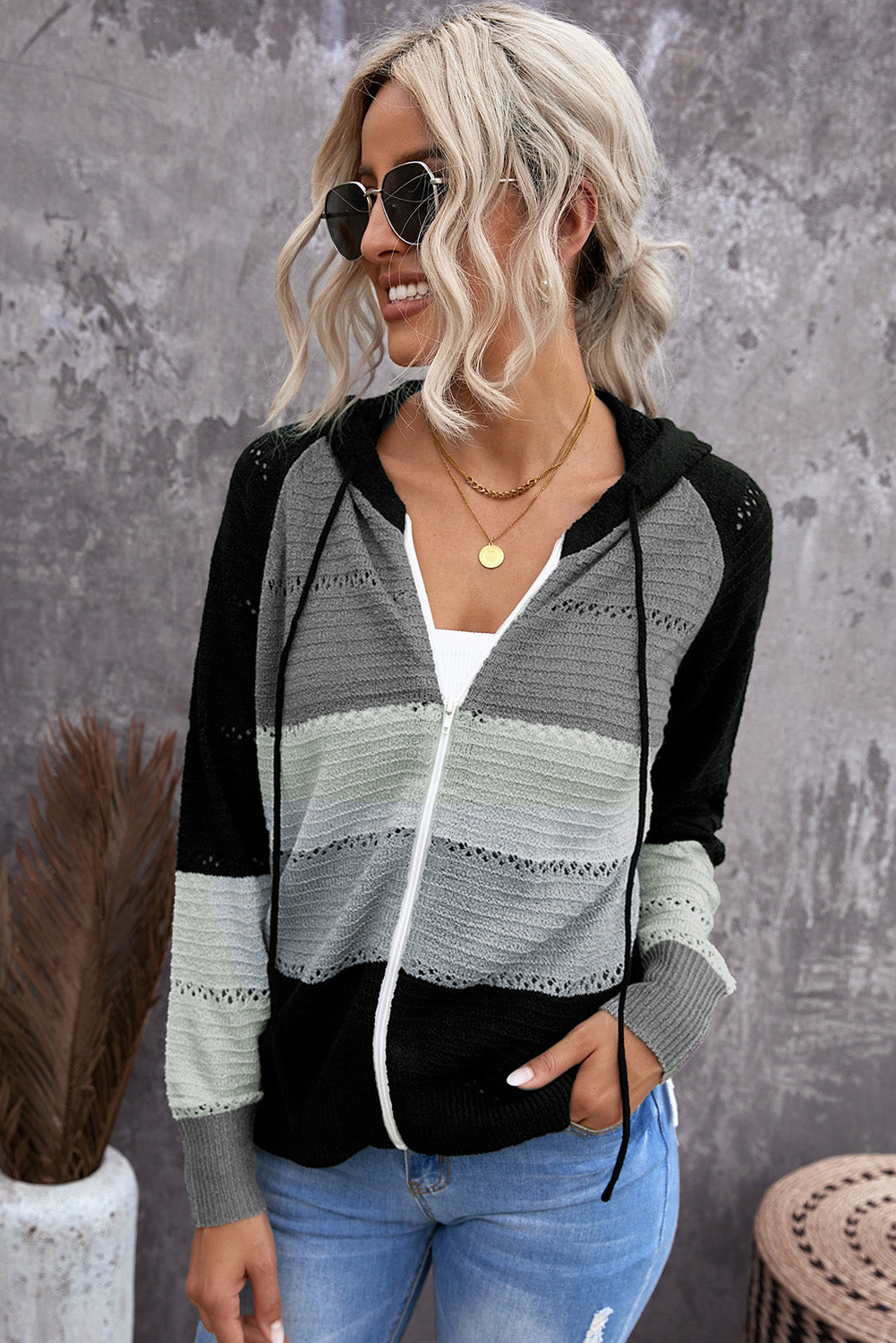 Zip-up hooded cardigan with black raglan sleeves and white/gray striped openwork knit