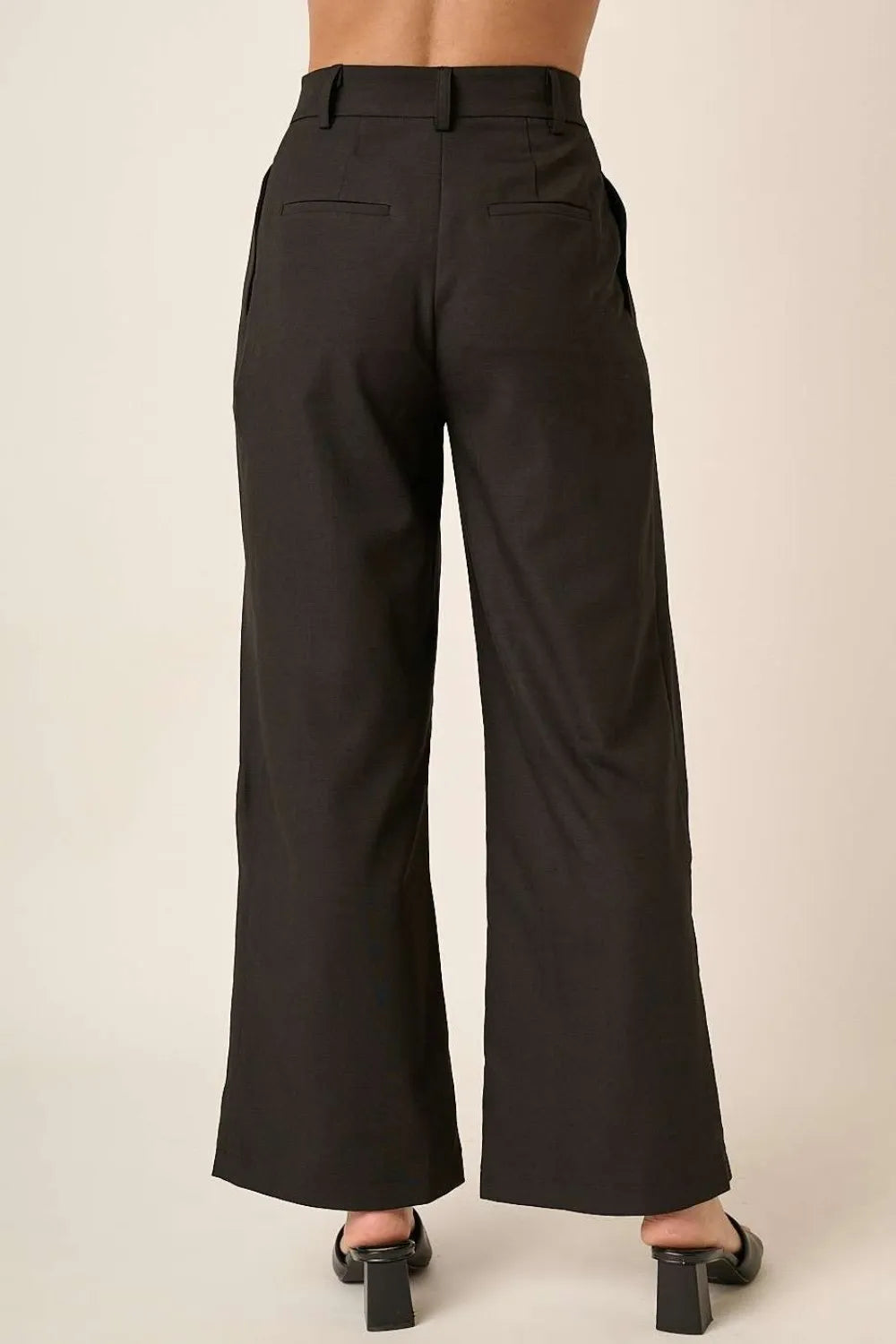 Black high-waisted wide-leg pants with belt loops, button closure, and pockets