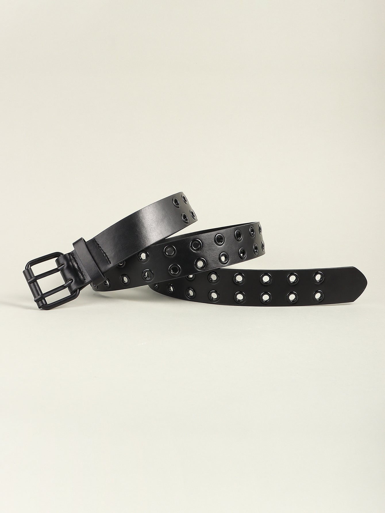 Black wide vegan leather belt with metal grommets and square buckle, angled view.