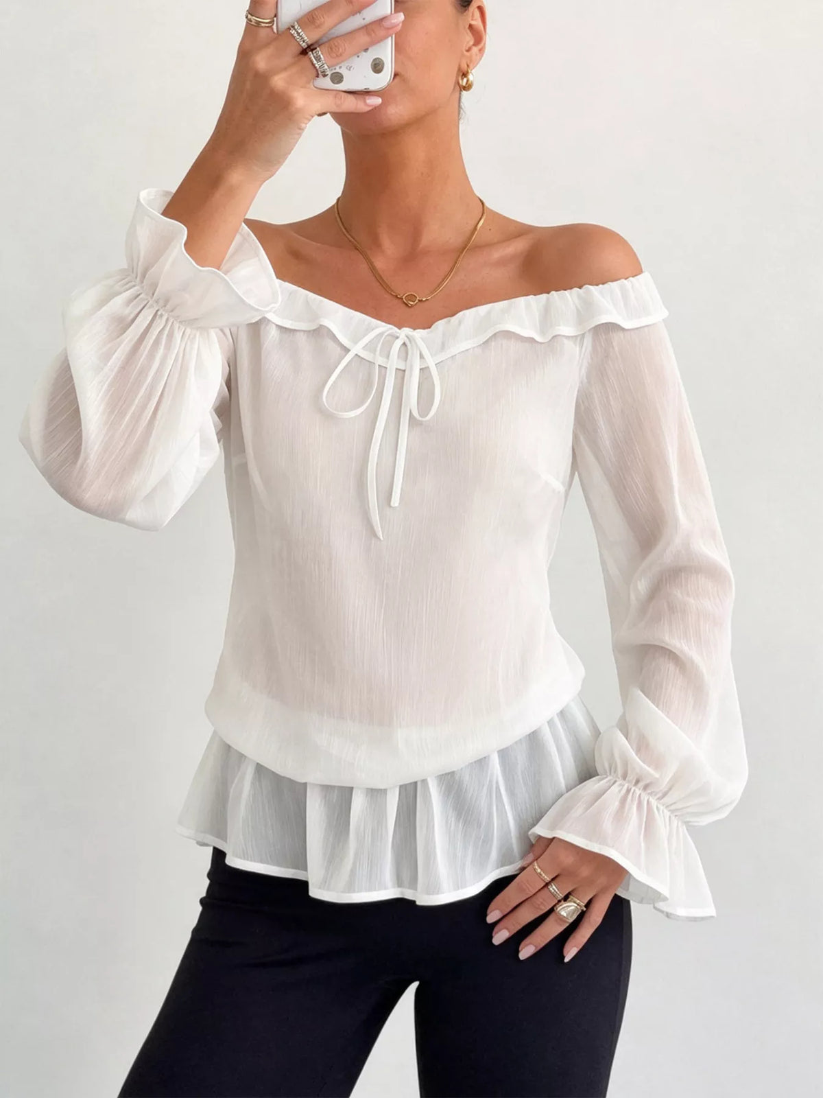 White off-shoulder chiffon blouse with ruffled neckline, drawstring tie, peplum hem