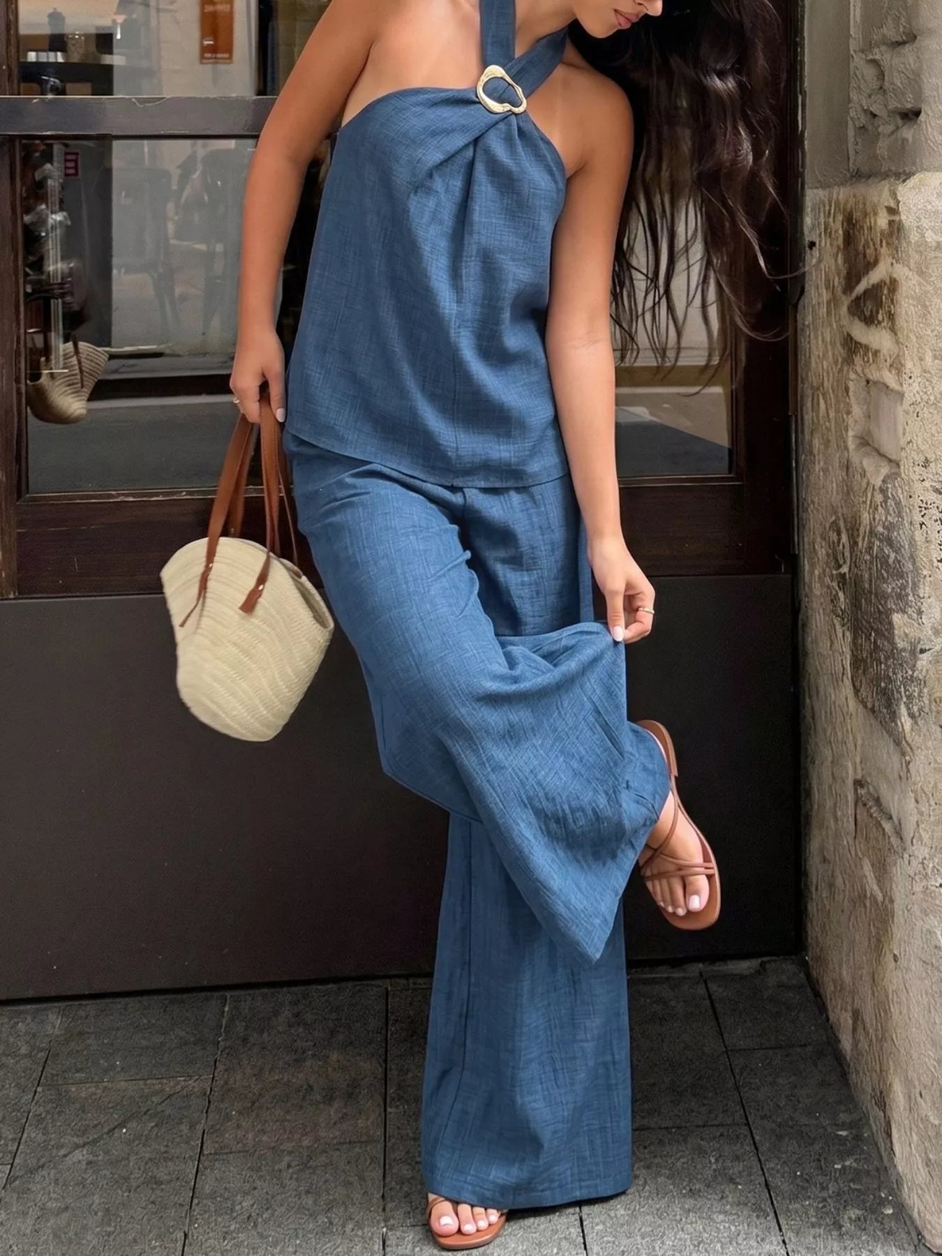 Navy blue halter neck top and wide-leg pants set with draped bow at neckline