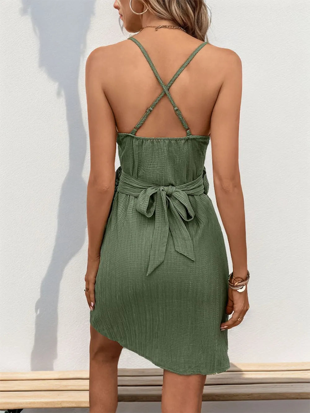 Perfee Crisscross Tied Surplice Mini Dress in olive green with cross-back straps and waist tie Trendsi.