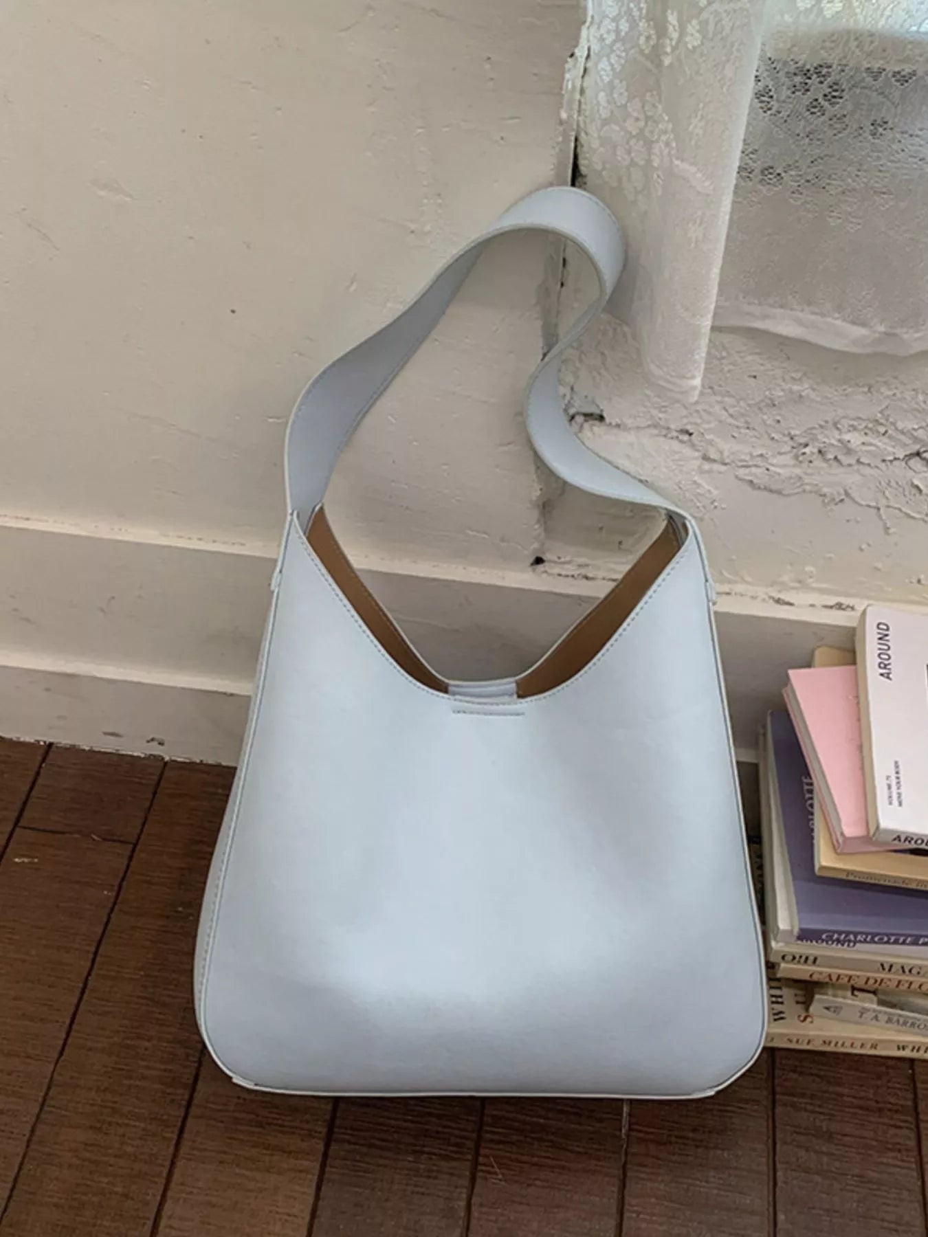 Light blue PU leather shoulder bag with curved handle and soft slouchy body