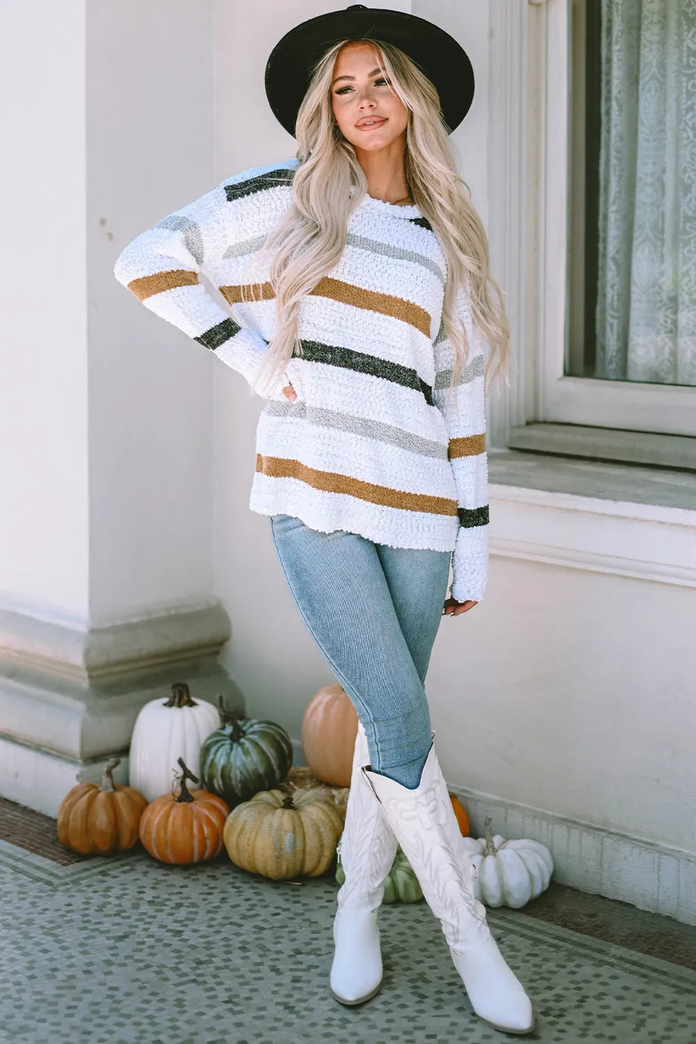 White striped round-neck sweater with green and tan stripes, long sleeves and relaxed shoulders
