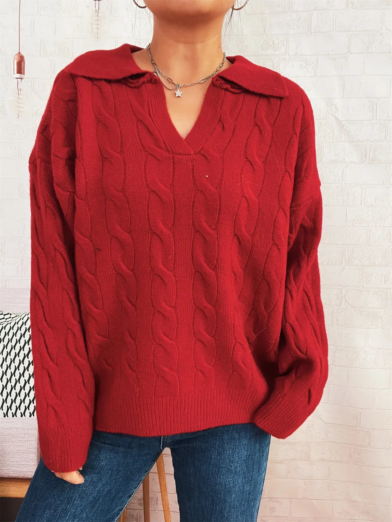 Red cable-knit V-neck Johnny collar sweater with raised cable pattern and ribbed hem