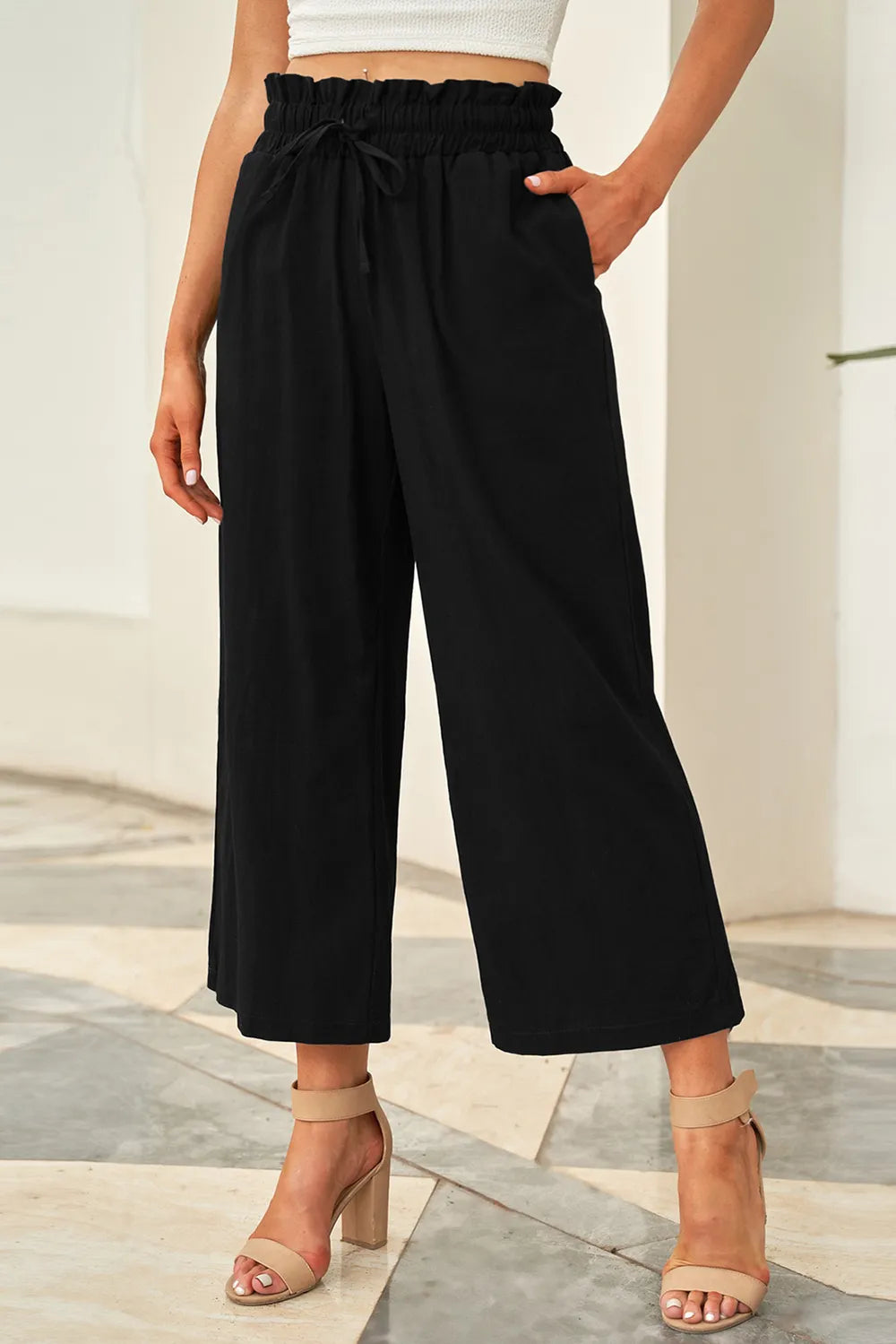 Black wide-leg pants with drawstring paperbag-style waist and relaxed ankle length