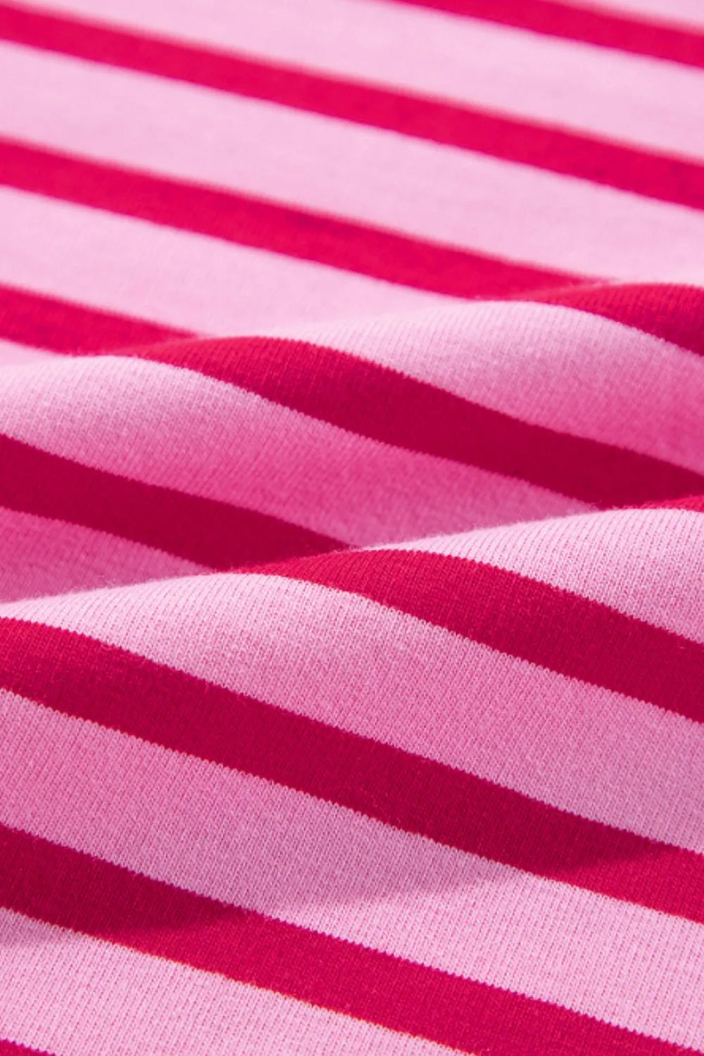 Hot pink and white striped sweatshirt fabric with soft knit texture.