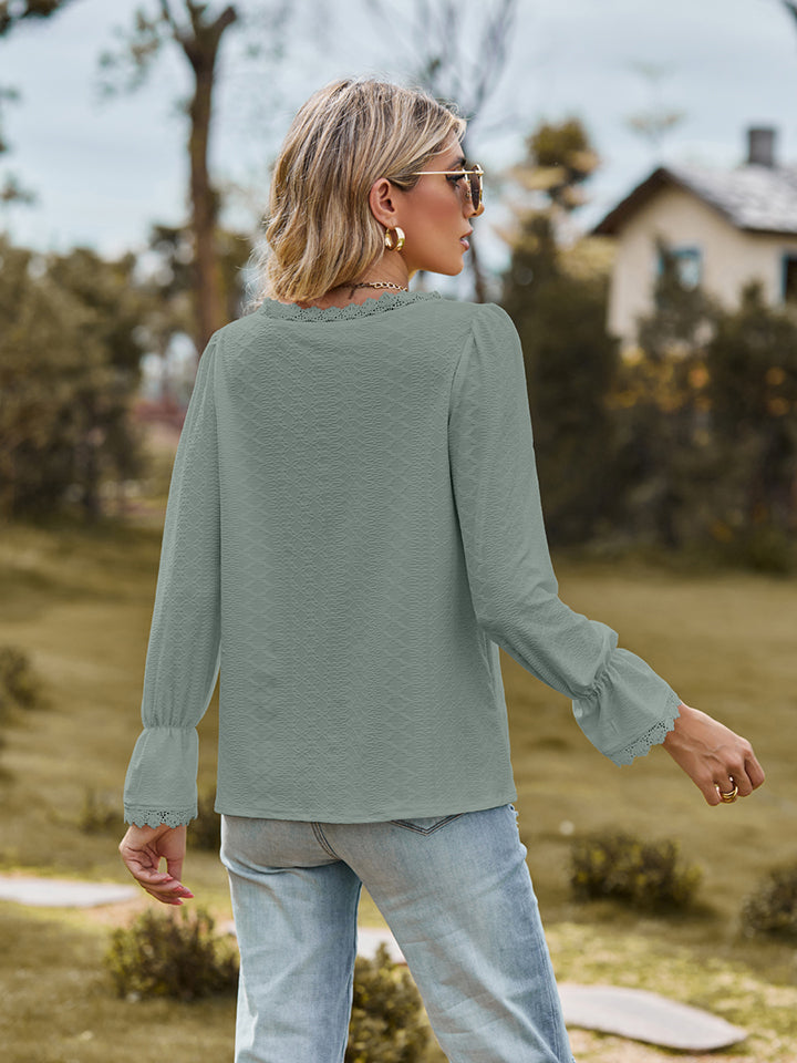 V-neck flounce-sleeve blouse in sage green, back view with long ruffled cuffs