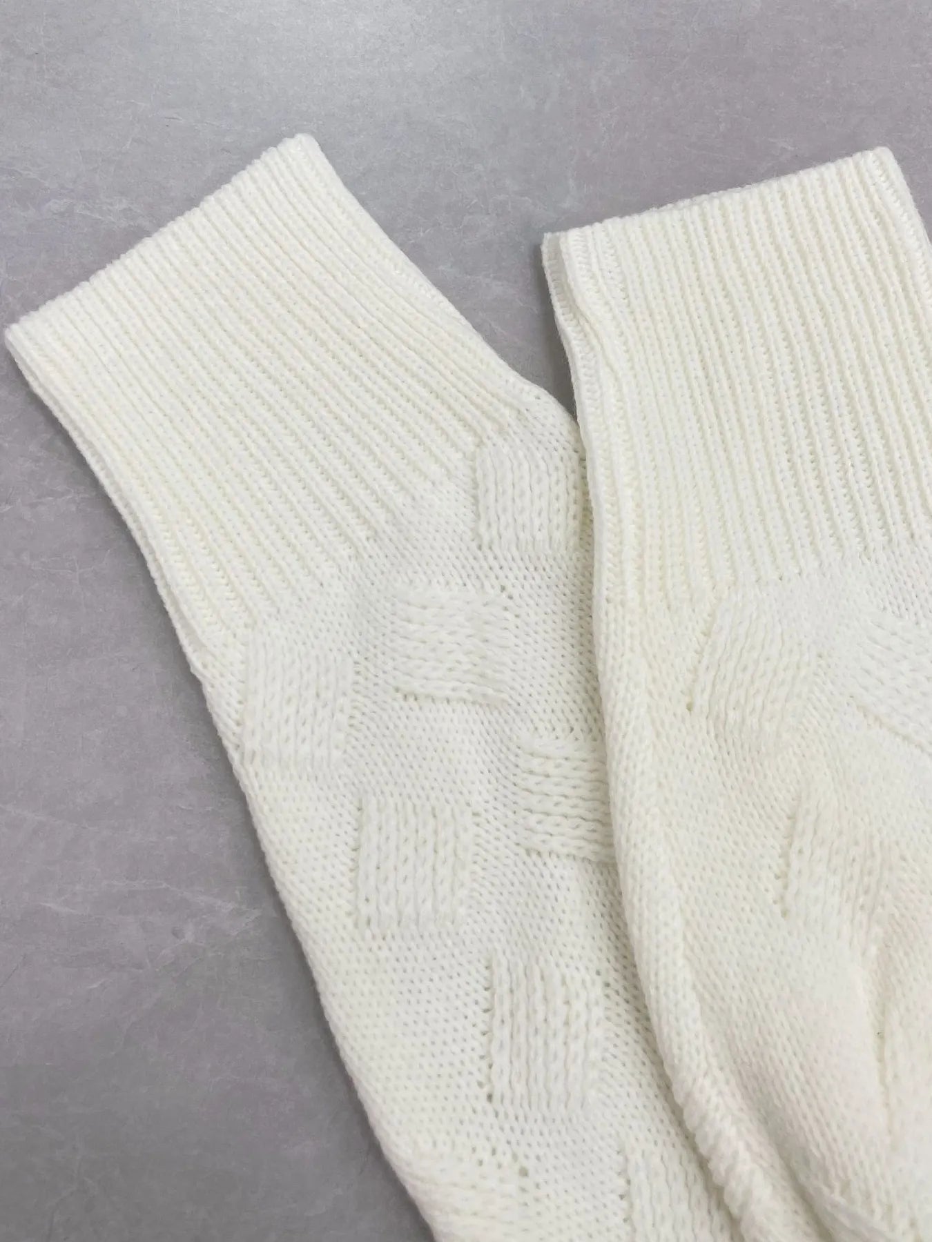 White sweater cuffs with chevron knit texture and ribbed trim